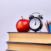 Back to school — clock, apple and books
