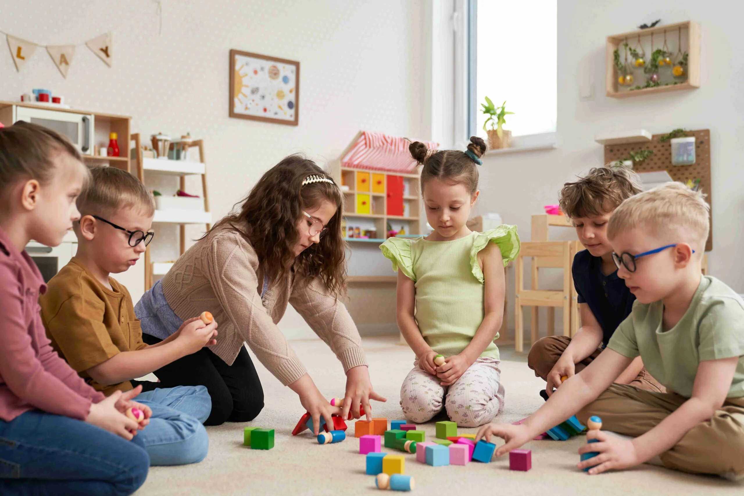Children doing sensory exercises with Montessori blocks in kindergarten