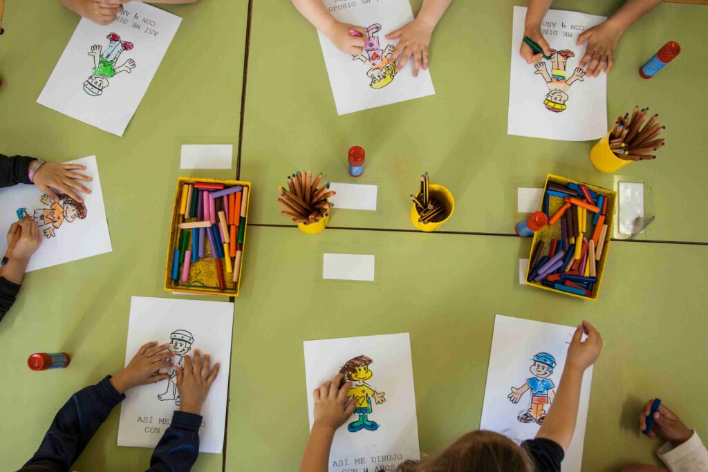 Kindergarten children working together on a floor activity, top-down view