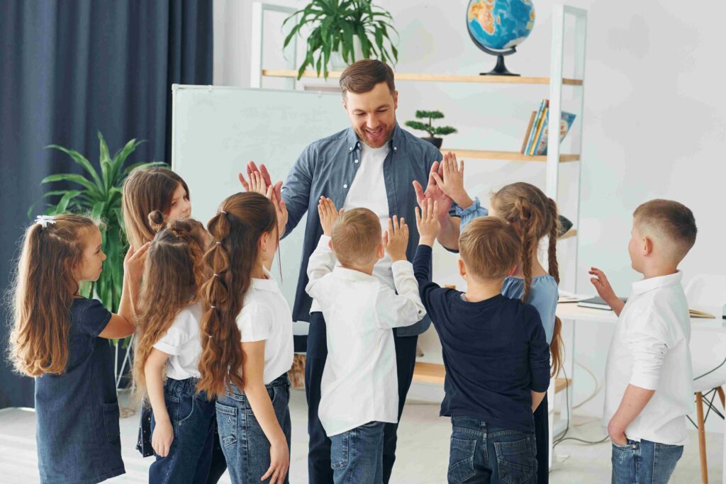 Children giving high fives in a school setting